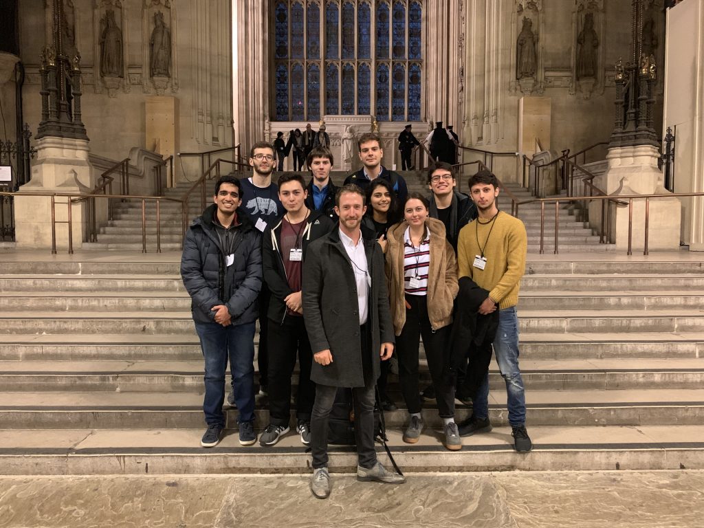 Group photo of Chris Henry at Parliament with a class of students